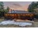Charming home exterior with covered patio, ideal for outdoor living and entertaining with sunset sky at 8140 Lightening View Dr, Parker, CO 80134