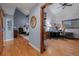 Hallway leading to a bedroom and an office area with wood floors and contemporary wall colors at 8140 Lightening View Dr, Parker, CO 80134