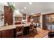 Spacious kitchen features an island with seating, wood cabinets, granite counters, and a sliding door to the patio at 8140 Lightening View Dr, Parker, CO 80134