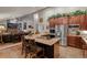 Gourmet kitchen featuring granite countertops, stainless steel appliances, island with cooktop, and seamless flow to living area at 8140 Lightening View Dr, Parker, CO 80134