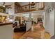 Open concept living room and dining room featuring high ceilings, natural light, wood floors and staircase at 8140 Lightening View Dr, Parker, CO 80134