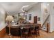Open-concept living area showcasing a brick fireplace, TV, bar seating, and an entrance to the staircase at 8140 Lightening View Dr, Parker, CO 80134