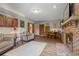 Finished basement living room has brick fireplace, wet bar and lots of natural light from windows at 8140 Lightening View Dr, Parker, CO 80134
