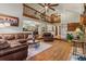 Living room showcasing open layout, vaulted ceiling, hardwood flooring, and natural light from large windows at 8140 Lightening View Dr, Parker, CO 80134