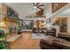 Cozy living room with hardwood floors, brick fireplace, and expansive windows showcasing the outdoor landscape at 8140 Lightening View Dr, Parker, CO 80134