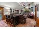 Inviting living room featuring a brick fireplace, built-in shelves, and an adjacent bar with seating at 8140 Lightening View Dr, Parker, CO 80134