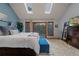 Relaxing main bedroom featuring skylights, a king bed, and a sliding glass door to the outside at 8140 Lightening View Dr, Parker, CO 80134