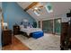 Bright main bedroom with vaulted ceilings, skylights, and a sliding glass door leading to a balcony at 8140 Lightening View Dr, Parker, CO 80134