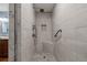 This is a newly renovated walk-in shower with custom tile work and a built-in seat, a design feature at 8140 Lightening View Dr, Parker, CO 80134