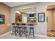 Finished basement bar area with seating, TV, and wooden countertops at 12121 Bryant St, Westminster, CO 80234