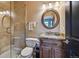 Bathroom featuring a shower with glass door, toilet, and vanity with mirror at 12121 Bryant St, Westminster, CO 80234