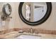 Close-up of bathroom vanity with granite countertop and mirror at 12121 Bryant St, Westminster, CO 80234