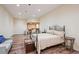Bedroom with wood floors, a bed with decorative pillows, and unique built-in shelving at 12121 Bryant St, Westminster, CO 80234