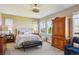 Primary bedroom with carpeting, wooden furniture, and multiple bright windows at 12121 Bryant St, Westminster, CO 80234