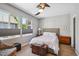 Cozy bedroom featuring two windows, a ceiling fan, and plush carpeting at 12121 Bryant St, Westminster, CO 80234
