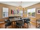 Formal dining room boasts hardwood floors, modern lighting, and large windows at 12121 Bryant St, Westminster, CO 80234