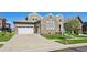 Charming stone home features an attached two-car garage and manicured lawn at 12121 Bryant St, Westminster, CO 80234