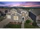 Beautiful stone home features a landscaped yard and a mountain view at sunset at 12121 Bryant St, Westminster, CO 80234
