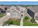 Beautiful home with stone facade, manicured landscaping, and a welcoming front entrance at 12121 Bryant St, Westminster, CO 80234