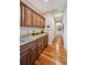 Hallway with wood flooring, custom cabinetry, granite countertops, and views of the home at 12121 Bryant St, Westminster, CO 80234