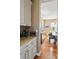Kitchen with granite counters leads to dining area with hardwood floors at 12121 Bryant St, Westminster, CO 80234