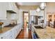 Bright kitchen with stainless steel appliances, granite counters, island seating, and wooden floors at 12121 Bryant St, Westminster, CO 80234