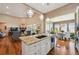 Open kitchen flows into living room and dining area, all with hardwood floors at 12121 Bryant St, Westminster, CO 80234