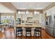 Open kitchen features a large island, granite countertops, and stainless steel appliances at 12121 Bryant St, Westminster, CO 80234