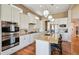 Bright kitchen with stainless steel appliances, granite counters, island seating, and wooden floors at 12121 Bryant St, Westminster, CO 80234