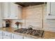 Granite countertops complement the stainless steel range and decorative tile backsplash at 12121 Bryant St, Westminster, CO 80234