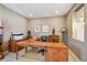 Comfortable home office with natural light, built-in shelving, and a spacious desk at 12121 Bryant St, Westminster, CO 80234