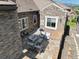 Stone patio area featuring comfortable outdoor seating, stone pillars, and a view at 12121 Bryant St, Westminster, CO 80234