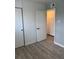 Bright bedroom features neutral walls, wood flooring, and closet space at 7620 Kearney Dr, Commerce City, CO 80022