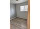 Comfortable bedroom with wood flooring, bright window, and neutral walls at 7620 Kearney Dr, Commerce City, CO 80022