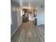 Spacious kitchen with gas range stove, white refrigerator, grey cabinets, and wood floors at 7620 Kearney Dr, Commerce City, CO 80022