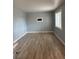 Inviting living room featuring neutral wall color, bright window, and wood-look flooring at 7620 Kearney Dr, Commerce City, CO 80022