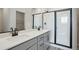Modern bathroom featuring double sinks, quartz countertops, and a glass-enclosed shower at 9465 Yampa St, Commerce City, CO 80022