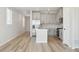 Open floor plan: kitchen with island, stainless appliances, hardwood floors, and grey cabinets at 9465 Yampa St, Commerce City, CO 80022