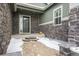 Front entry with stonework, a dark door, and a small patio at 26674 E Phillips Pl, Aurora, CO 80016