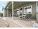 Covered porch with seating and outdoor dining area at 26674 E Phillips Pl, Aurora, CO 80016