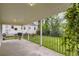 Covered back porch with a black metal railing offers a serene view of the green backyard at 2634 S Humboldt St, Denver, CO 80210