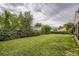 Expansive backyard features lush lawn, mature trees, and a tranquil, private outdoor space for relaxation and recreation at 2634 S Humboldt St, Denver, CO 80210