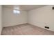 Unfinished basement space with neutral carpeting and paint, offering versatility for various uses at 2634 S Humboldt St, Denver, CO 80210