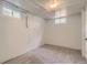 Unfinished basement, carpeted, featuring windows and neutral tones at 2634 S Humboldt St, Denver, CO 80210