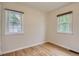Bright bedroom with hardwood floors, neutral paint, and two windows providing ample natural light at 2634 S Humboldt St, Denver, CO 80210