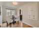 Elegant dining room with a glass table, white chairs, and hardwood floors at 2634 S Humboldt St, Denver, CO 80210
