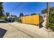 Bright yellow wooden driveway gate leading to a property at 2634 S Humboldt St, Denver, CO 80210
