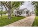 Well-maintained home featuring a lush lawn, mature trees, and a detached garage at 2634 S Humboldt St, Denver, CO 80210