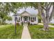 Charming home with beautiful landscaping, flower boxes, rocking chairs, and a welcoming entrance at 2634 S Humboldt St, Denver, CO 80210