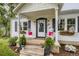 Inviting front porch with rocking chairs, flower boxes, and a welcoming wreath at 2634 S Humboldt St, Denver, CO 80210